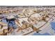 Aerial view of a house with a snow-covered yard in a neighborhood setting at 23579 E Swallow Cir, Aurora, CO 80016