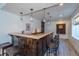 Basement bar with wood counters, stylish lighting, and seating for entertaining, complete with wood floor at 23579 E Swallow Cir, Aurora, CO 80016