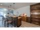 Basement bar with granite counters, stylish lighting, and seating, perfect for entertainment, plus mini appliances at 23579 E Swallow Cir, Aurora, CO 80016