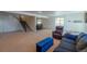 Open basement area with cozy seating, stairs, and bar area bathed in natural light from the large window at 23579 E Swallow Cir, Aurora, CO 80016