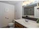 Bathroom features a single sink vanity, toilet and tiled shower with glass door at 23579 E Swallow Cir, Aurora, CO 80016