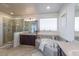 Luxurious bathroom features a soaking tub, walk-in shower, and double vanity sinks at 23579 E Swallow Cir, Aurora, CO 80016