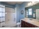 Well-lit bathroom featuring a shower-tub combo, dark wood vanity, toilet, and neutral wall color at 23579 E Swallow Cir, Aurora, CO 80016