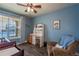 Charming Bedroom with light blue walls, built-in desk, and crib at 23579 E Swallow Cir, Aurora, CO 80016