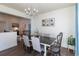 This spacious dining room features modern decor and elegant lighting, creating a warm ambiance at 23579 E Swallow Cir, Aurora, CO 80016