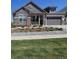 Charming two-story home featuring stone accents, a well-manicured lawn, and an attached two-car garage at 23579 E Swallow Cir, Aurora, CO 80016