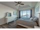 Light-filled main bedroom has hardwood floors, large window, and dresser with mirror at 23579 E Swallow Cir, Aurora, CO 80016