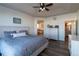 Cozy main bedroom with decorative tray ceiling, hardwood floors, and access to ensuite bathroom at 23579 E Swallow Cir, Aurora, CO 80016