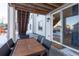 Covered outdoor patio with dining set and view of the backyard, perfect for al fresco dining and relaxation at 23579 E Swallow Cir, Aurora, CO 80016