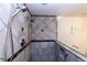 Bathroom tiled shower with two shower heads, built in niche, and a glass door at 23579 E Swallow Cir, Aurora, CO 80016