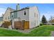 Back exterior view of a townhome featuring a fenced yard and partial view of the neighbor's home at 9188 W Ontario Dr, Littleton, CO 80128
