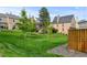 Well-maintained lawn with young trees and a view of the neighboring townhouse exteriors at 9188 W Ontario Dr, Littleton, CO 80128