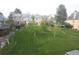 Grassy backyard surrounded by neighboring townhomes with a variety of neutral exterior colors at 9188 W Ontario Dr, Littleton, CO 80128