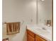 Cozy bathroom featuring a single sink vanity, large mirror, and modern fixtures at 9188 W Ontario Dr, Littleton, CO 80128