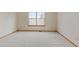 Bright bedroom with a large window offers plenty of natural light and neutral carpet at 9188 W Ontario Dr, Littleton, CO 80128