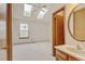 Bright bedroom with skylights, carpet flooring, window, and adjacent vanity area at 9188 W Ontario Dr, Littleton, CO 80128