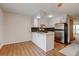 Open kitchen layout with stainless steel appliances, granite countertops, and wood-look floors at 9188 W Ontario Dr, Littleton, CO 80128