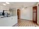 Open concept kitchen includes white cabinets, granite countertops, modern faucet, and pantry at 9188 W Ontario Dr, Littleton, CO 80128