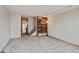 Open living room features carpet, staircase, shelving, and modern lighting at 9188 W Ontario Dr, Littleton, CO 80128