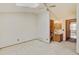 Bright main bedroom features a skylight, a ceiling fan, neutral carpet and attached bathroom at 9188 W Ontario Dr, Littleton, CO 80128