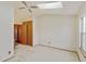 Main bedroom offers natural light, a ceiling fan and adjacent wardrobe with a full-length mirror at 9188 W Ontario Dr, Littleton, CO 80128