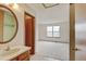 Main bedroom boasts ample space, a large window, and an ensuite bathroom with a skylight at 9188 W Ontario Dr, Littleton, CO 80128
