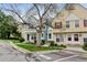 Street view of lovely townhomes with well-manicured lawns, trees, and nearby parking at 9188 W Ontario Dr, Littleton, CO 80128