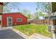 Backyard with a detached garage, well-maintained grass, and privacy fence at 4945 Perry St, Denver, CO 80212
