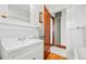 Bathroom featuring a wood door, vanity with white countertop, and a glimpse of the bathtub at 4945 Perry St, Denver, CO 80212