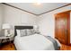 Comfortable bedroom featuring a queen bed with plush bedding, complemented by hardwood floors and natural light at 4945 Perry St, Denver, CO 80212