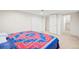 Bedroom with plush carpeting and a comfortable bed setup with a colorful quilt at 4945 Perry St, Denver, CO 80212