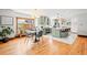 Open concept dining room featuring hardwood floors, modern light fixture, and kitchen views at 4945 Perry St, Denver, CO 80212