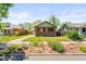 Charming brick home with inviting front porch surrounded by landscaping and a well-manicured lawn at 4945 Perry St, Denver, CO 80212