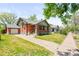 Charming brick home with a well-maintained front yard and inviting curb appeal in a desirable neighborhood at 4945 Perry St, Denver, CO 80212