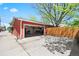 Exterior view of a detached garage featuring a red exterior and a driveway at 4945 Perry St, Denver, CO 80212