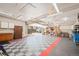 Spacious garage featuring a workbench, storage, and a durable checkered floor with a pop of red trim at 4945 Perry St, Denver, CO 80212