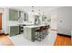 Modern kitchen featuring green cabinetry, marble countertops, and stainless steel appliances at 4945 Perry St, Denver, CO 80212