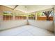 Well-lit sunroom with concrete flooring and an open view of the backyard and fence at 4945 Perry St, Denver, CO 80212