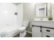 Charming bathroom with white vanity and drawers, and a shower-tub with white tile at 12558 E Tennessee Cir, Aurora, CO 80012