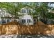 Charming townhouse exterior with wood fence, lush green trees, and natural light at 12558 E Tennessee Cir, Aurora, CO 80012