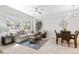 Bright living room featuring a comfortable sofa, decorative pillows, and a ceiling fan at 12558 E Tennessee Cir, Aurora, CO 80012