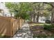 Exterior shot of a sidewalk lined with lush, mature trees at 12558 E Tennessee Cir, Aurora, CO 80012