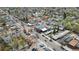Aerial view of a neighborhood with a commercial area featuring local businesses and tree-lined streets at 610 E Baseline Rd, Lafayette, CO 80026
