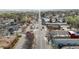 Aerial view down a commercial street with local businesses and car-lined roads in a neighborhood at 610 E Baseline Rd, Lafayette, CO 80026