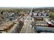 Aerial view down a commercial street with local businesses and car-lined roads in a neighborhood at 610 E Baseline Rd, Lafayette, CO 80026