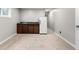 Basement area with wood cabinets, sink, and full-size refrigerator at 610 E Baseline Rd, Lafayette, CO 80026