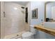 Bathroom with a modern shower, floating wood vanity, and updated toilet at 610 E Baseline Rd, Lafayette, CO 80026