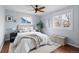 Bright bedroom featuring a ceiling fan, hardwood floors, and two windows for ample natural light at 610 E Baseline Rd, Lafayette, CO 80026