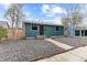 Attractive home with a teal exterior, dark trim, a gravel front yard and a concrete walkway at 610 E Baseline Rd, Lafayette, CO 80026