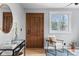 Cozy living room with a wooden door, sleek furniture, and bright natural light at 610 E Baseline Rd, Lafayette, CO 80026